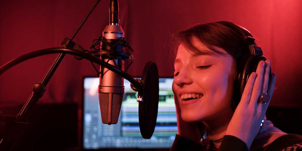 Girl singing in a recording studio